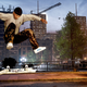 An image from Tony Hawk's Pro Skater 1+2 depicting a skateboarder doing a kickflip while streetskating in the dark.
